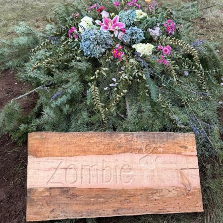 salvaged log headstone grave marker for pet dog named Zombie