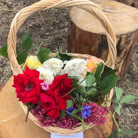 mixed flowers in basket at natural burial service